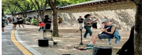 首爾德壽宮石牆路街頭表演，市民與遊客漫步欣賞音樂